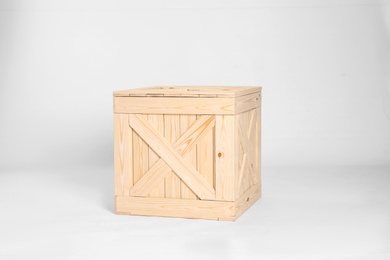 Photo of One closed wooden crate on grey background