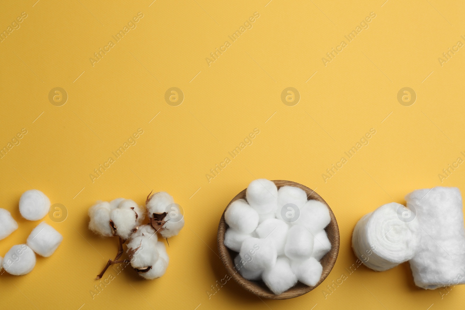 Photo of Flat lay composition with cotton rolls and balls on color background, space for text