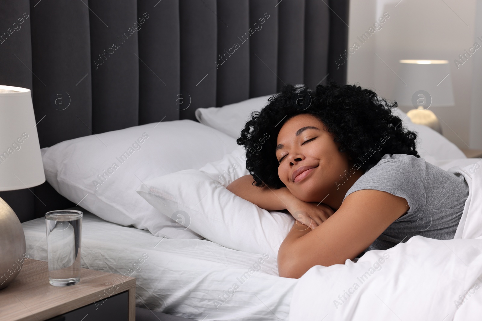 Photo of Beautiful young woman sleeping in soft bed at home