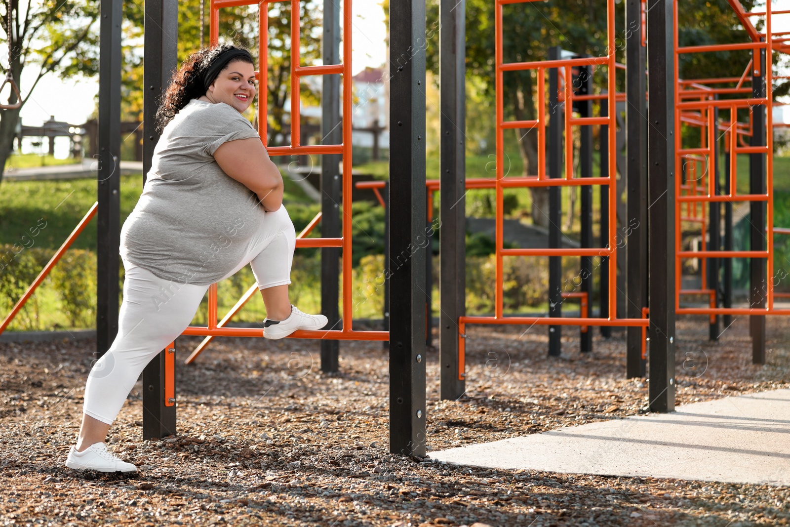 Photo of Beautiful overweight woman training on sports ground