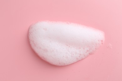 Photo of Sample of fluffy foam on pink background, top view