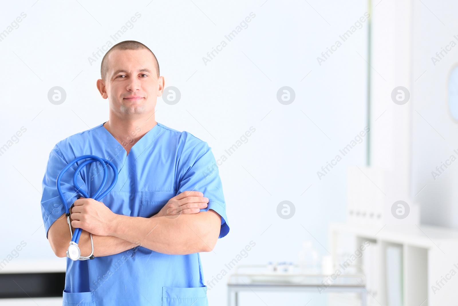 Photo of Portrait of medical assistant with stethoscope in hospital. Space for text