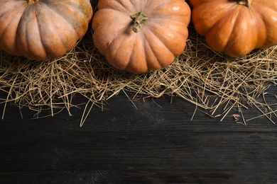 Flat lay composition with different ripe pumpkins on wooden background, space for text. Holiday decoration