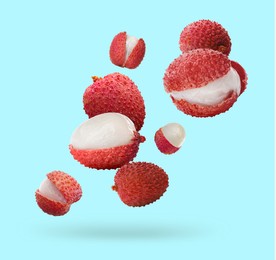 Image of Fresh lychees falling on light blue background