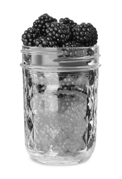 Photo of Fresh ripe blackberries in glass jar isolated on white