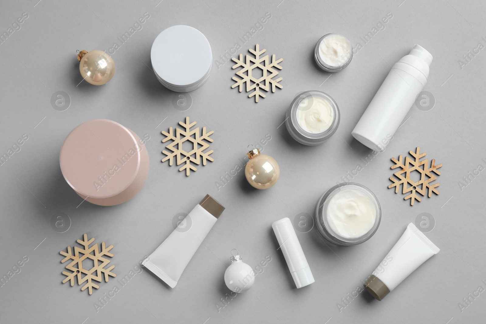 Photo of Flat lay composition with different cosmetic products on light grey background. Winter care