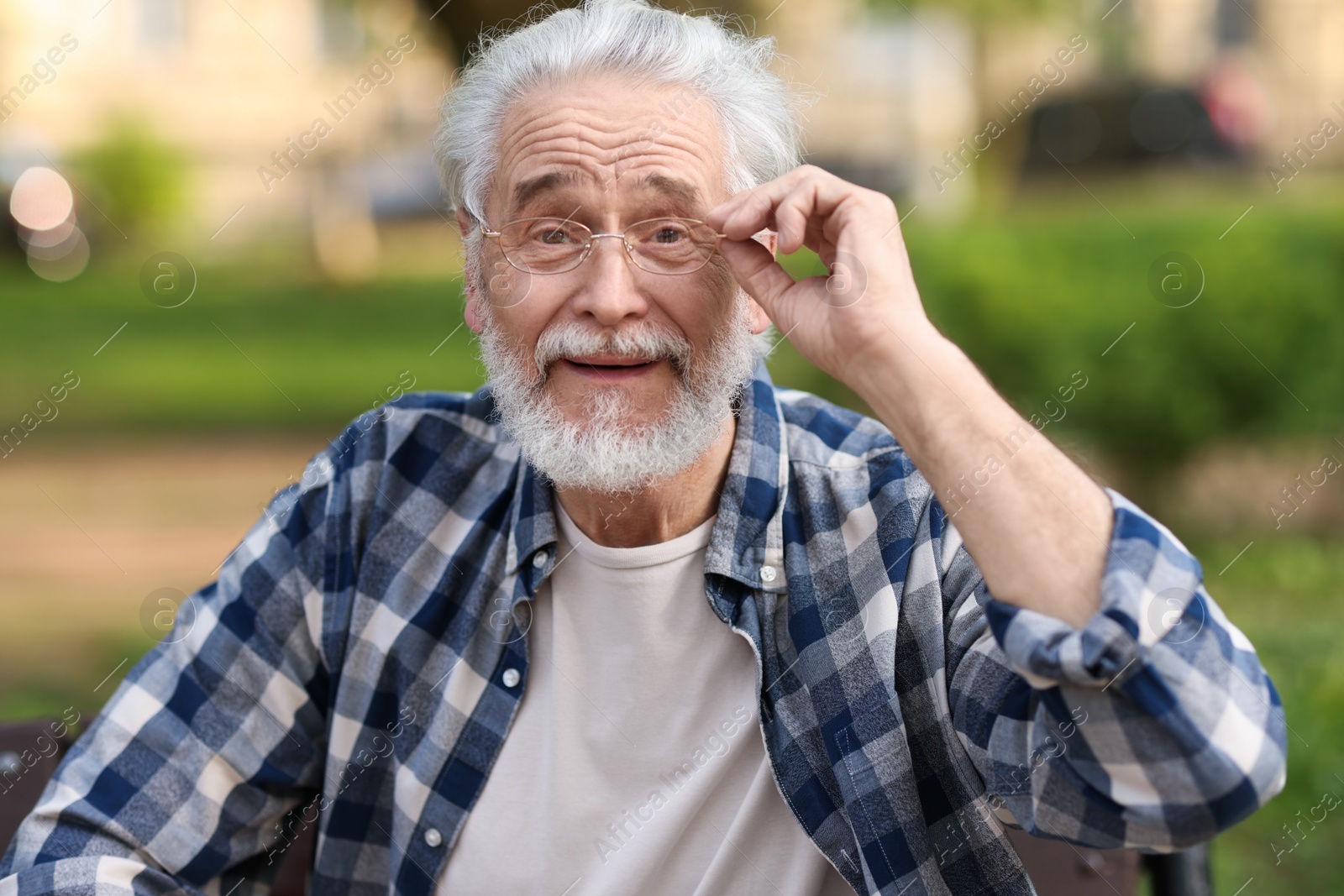 Photo of Portrait of happy grandpa with glasses outdoors