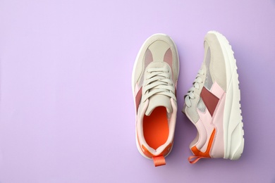 Photo of Pair of stylish shoes on lilac background, top view. Space for text