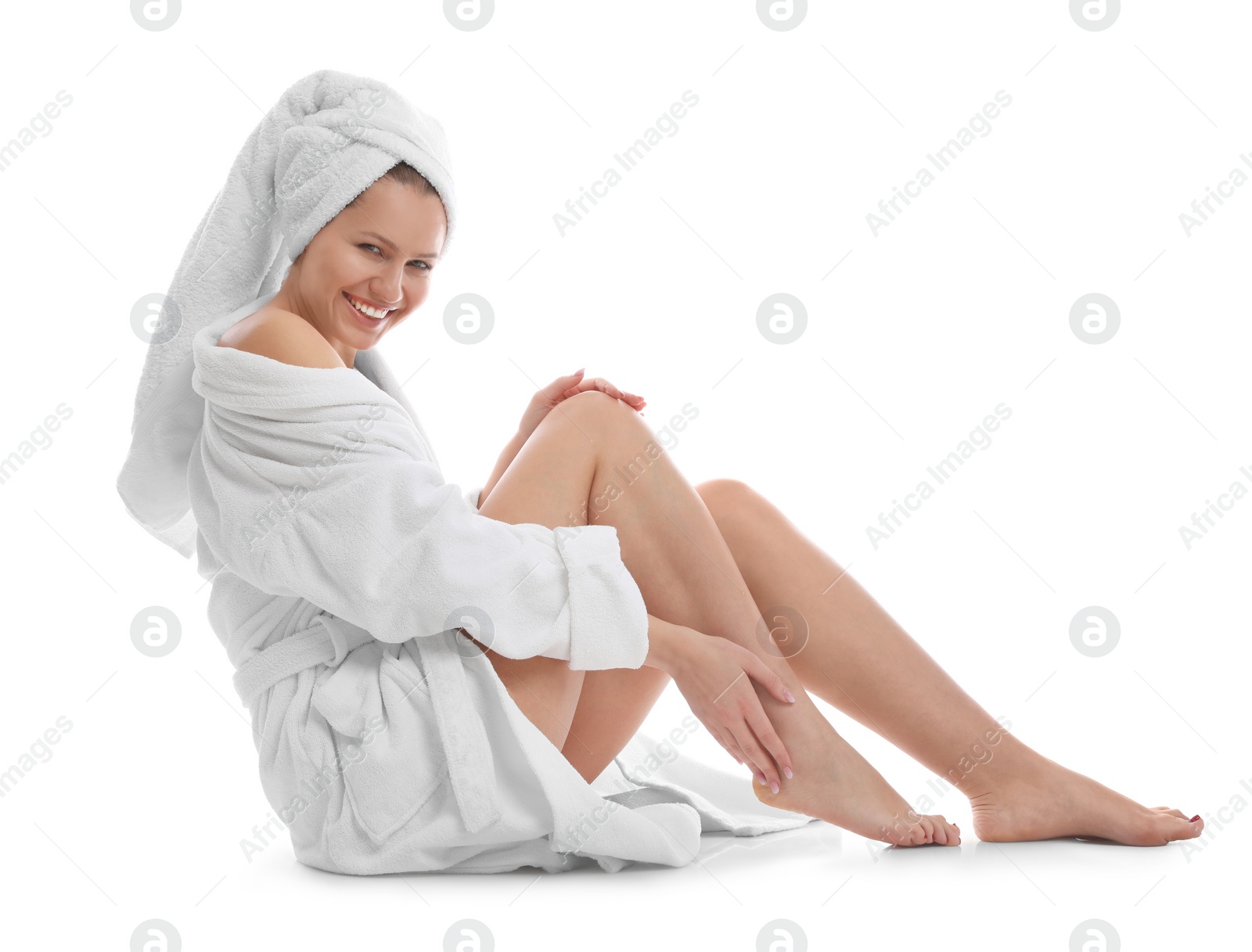 Photo of Young woman in bathrobe on white background