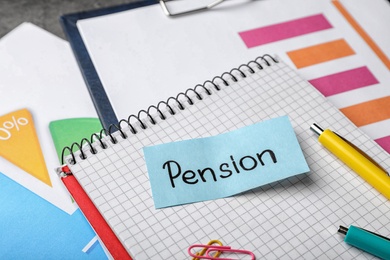 Photo of Paper with word PENSION and stationery on notebook page