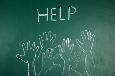 Drawing of human hands and word "Help" on chalkboard