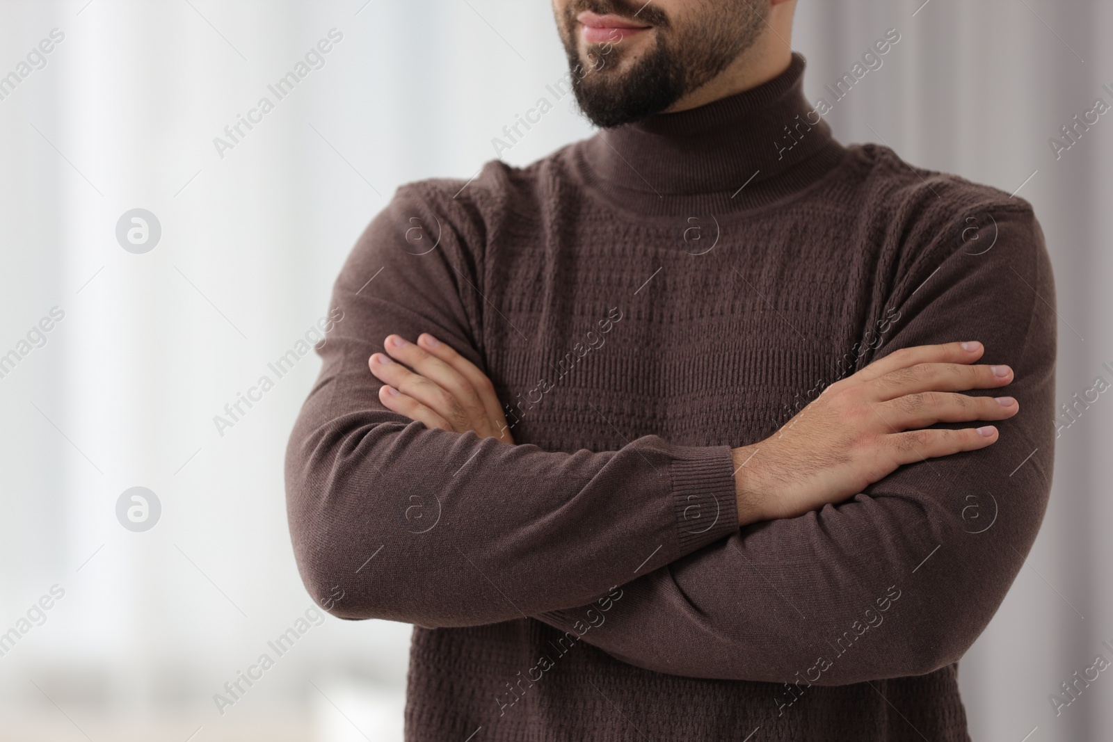 Photo of Man in stylish sweater against blurred background, closeup