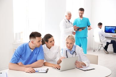 Photo of Group of doctors attending meeting in clinic. Cardiology conference