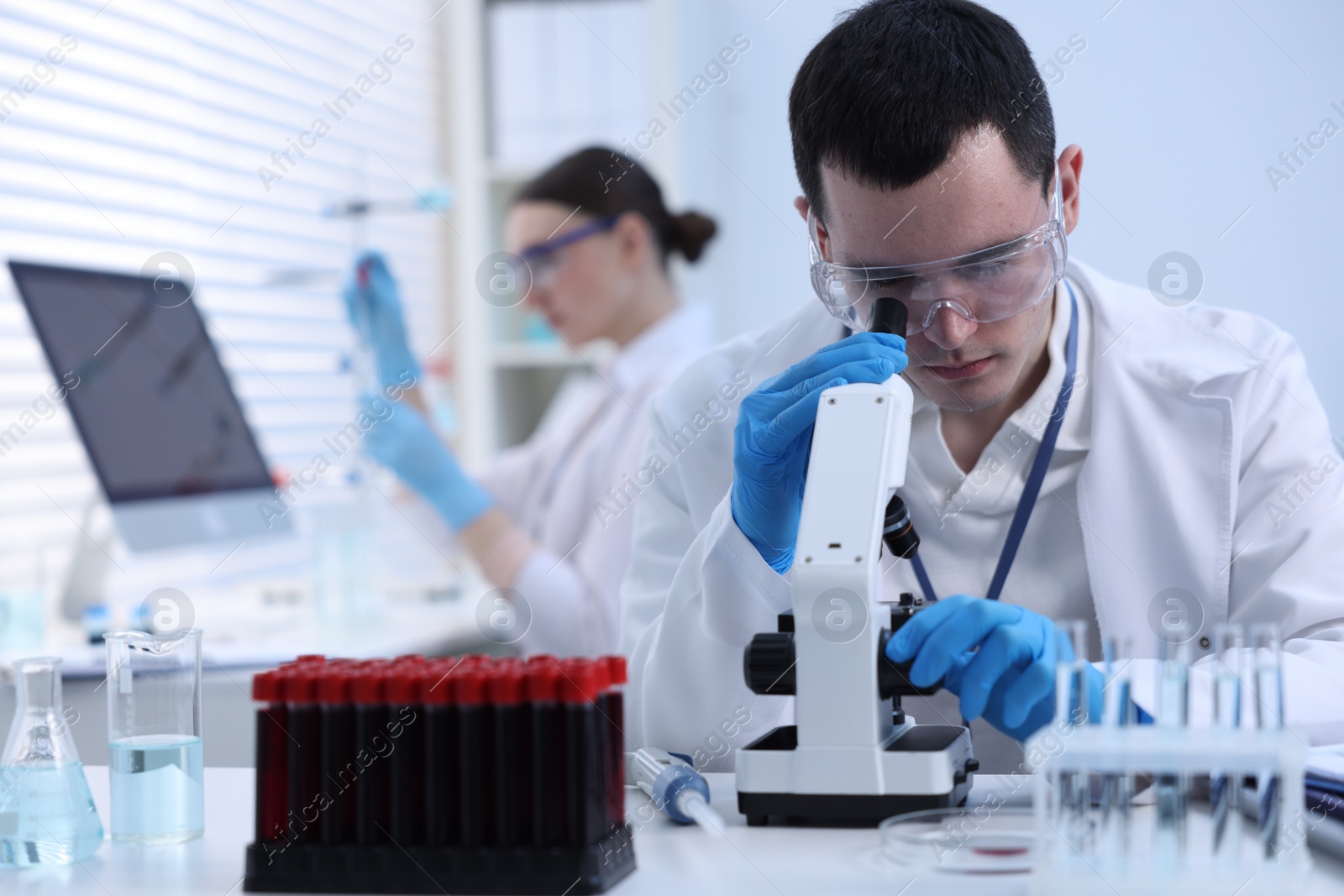 Photo of Scientist working with microscope in laboratory. Medical research