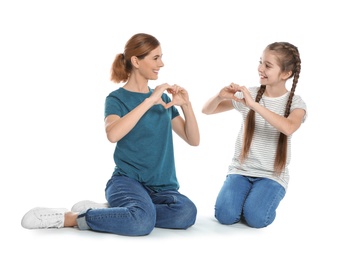 Photo of Hearing impaired mother and her child talking with help of sign language on white background