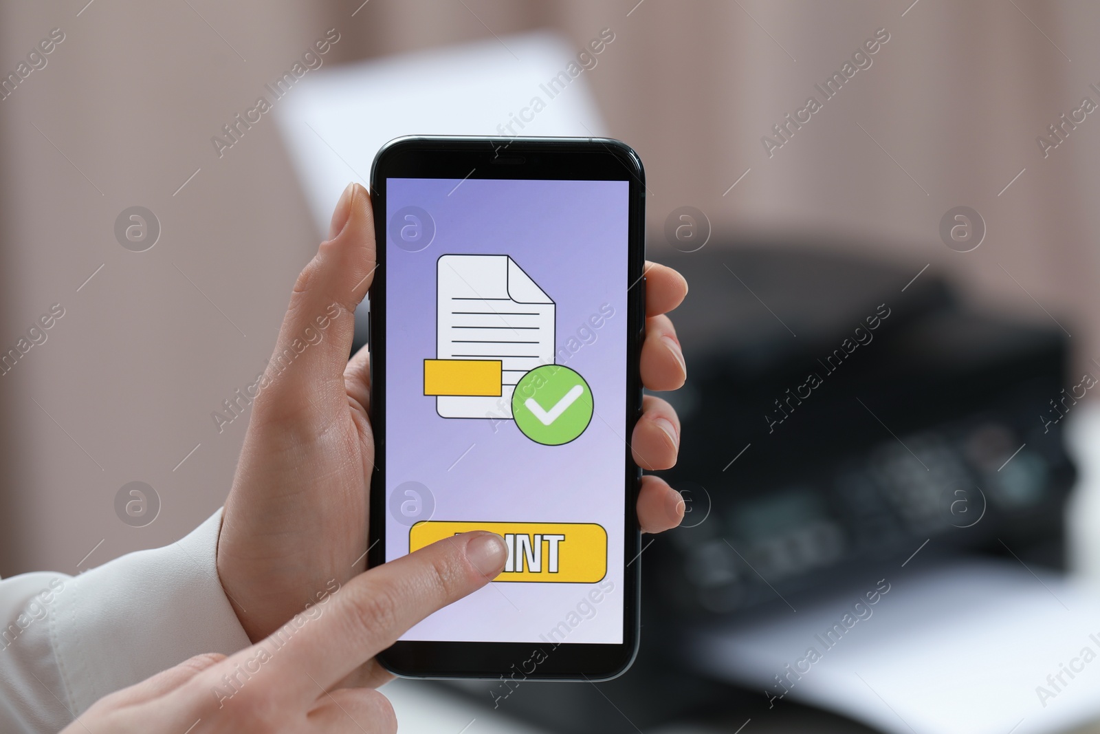 Photo of Man using printer management application on mobile phone in office, closeup