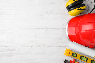 Photo of Flat lay composition with different construction tools on white wooden background. Space for text