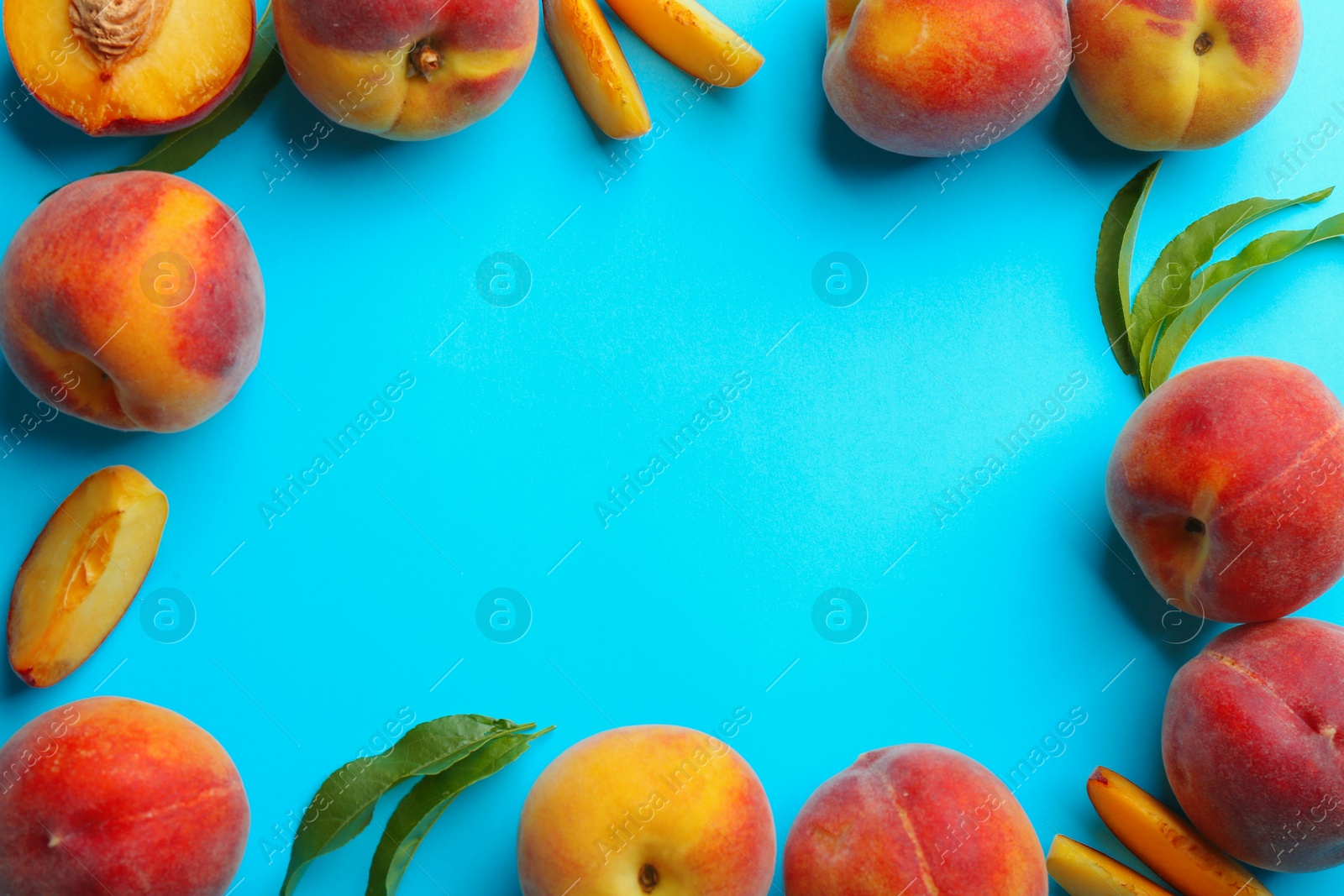 Photo of Flat lay composition with fresh peaches on blue background. Space for text