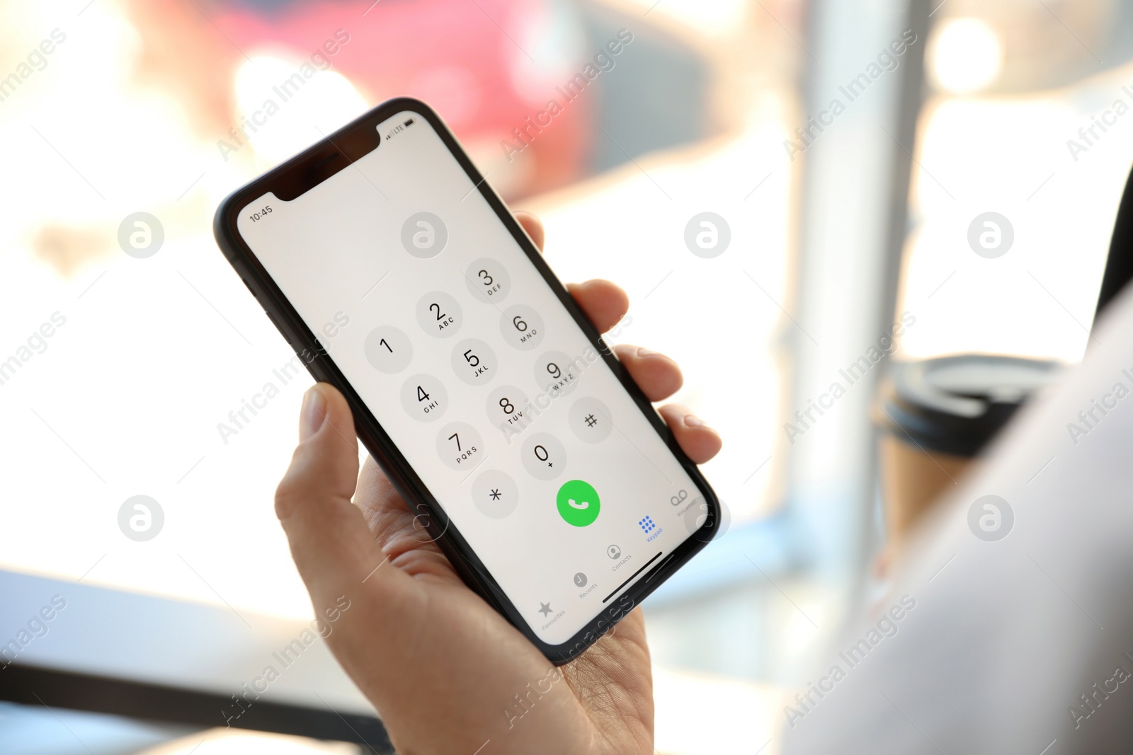 Photo of MYKOLAIV, UKRAINE - MARCH 16, 2020: Man holding iPhone 11 with keypad on screen indoors, closeup