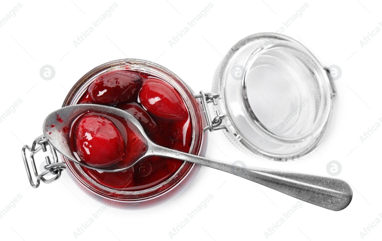 Photo of Delicious dogwood jam with berries in glass jar and spoon isolated on white, top view