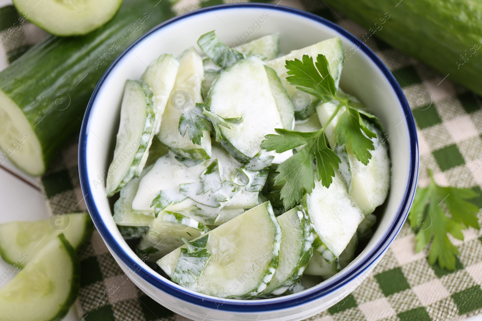 Photo of Delicious cucumber salad in bowl on table, closeup