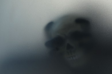 Photo of Silhouette of creepy ghost with skull behind cloth, space for text