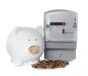 Electricity meter, piggy bank and coins on white background