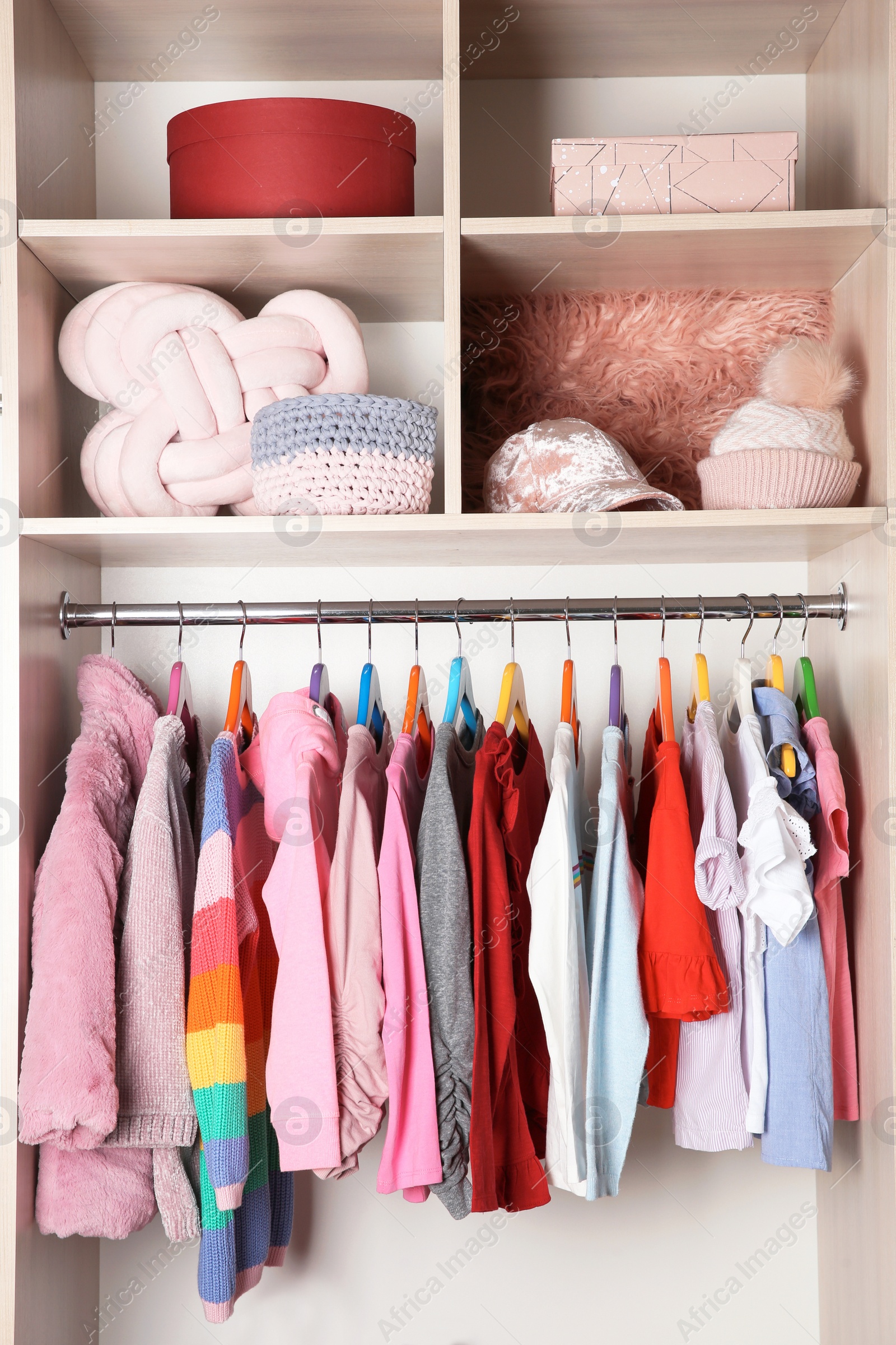 Photo of Wardrobe with stylish girl's clothes hanging on rack