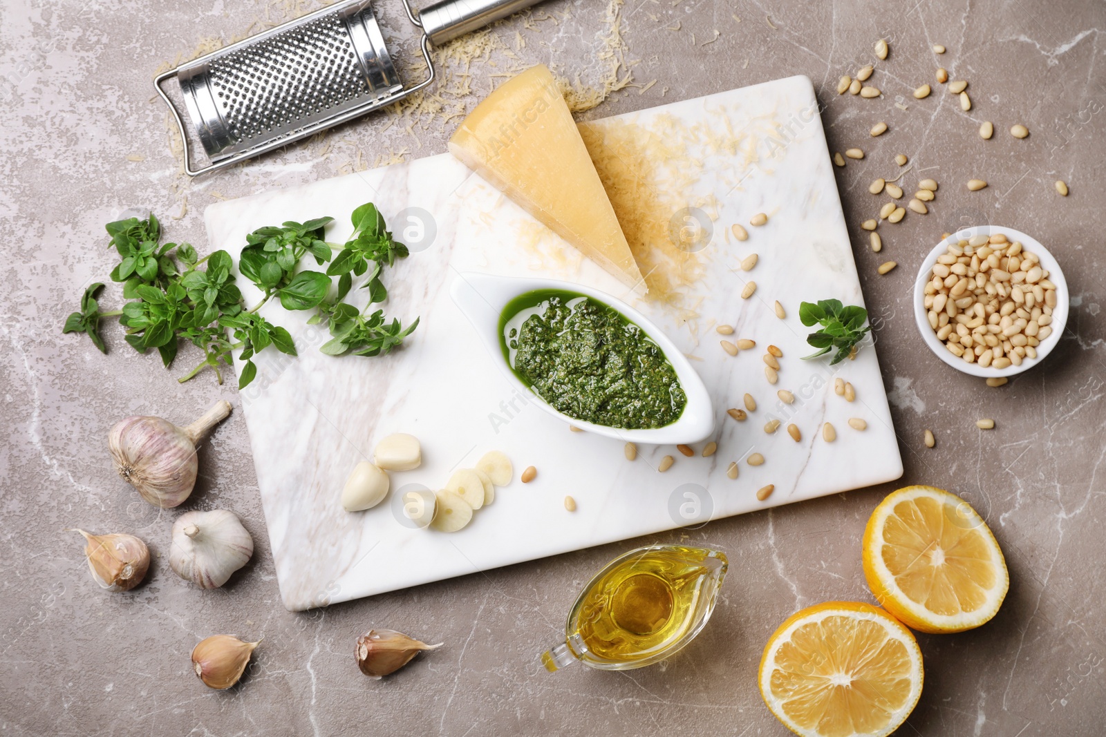 Photo of Flat lay composition with homemade basil pesto sauce and ingredients on table