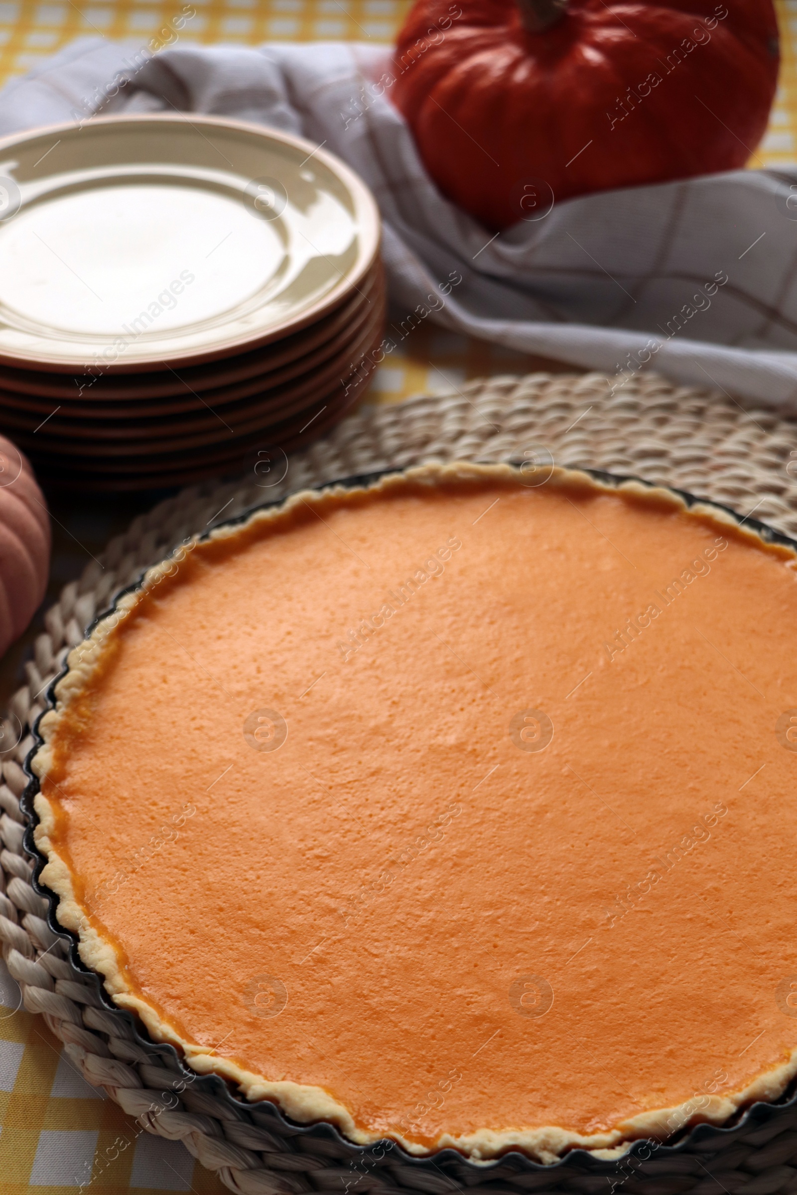 Photo of Delicious homemade pumpkin pie in baking dish on table