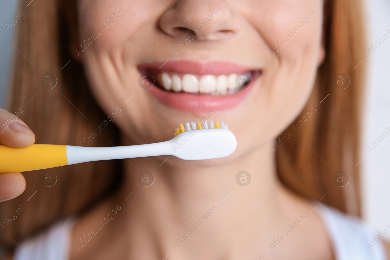 Photo of Smiling woman with toothbrush, closeup. Dental care