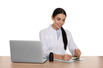 Photo of Professional pharmacist working at table against white background
