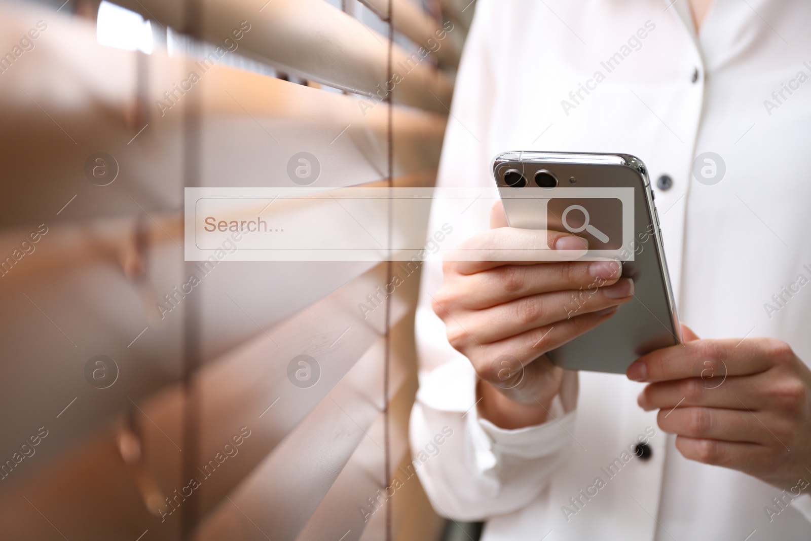 Image of Search bar of website near smartphone. Woman using device indoors, closeup