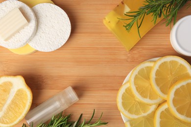 Lemon face cleanser. Fresh citrus fruits, rosemary and personal care products on wooden table, flat lay