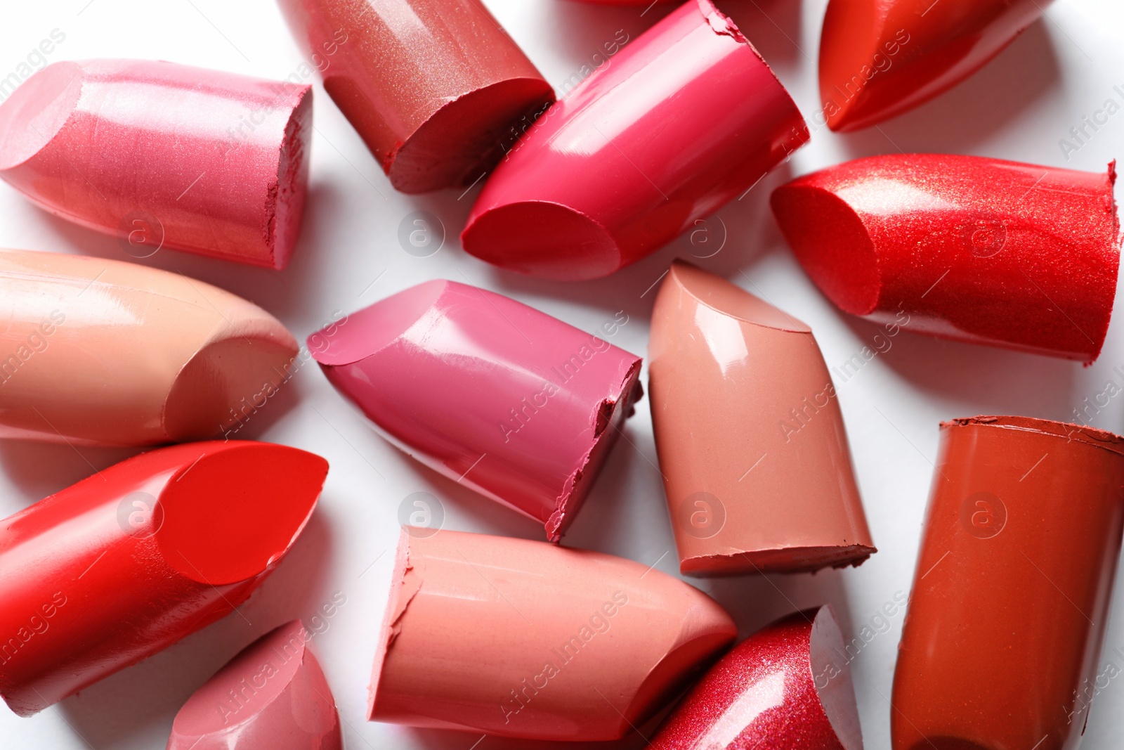 Photo of Collection of lipsticks on white background, top view