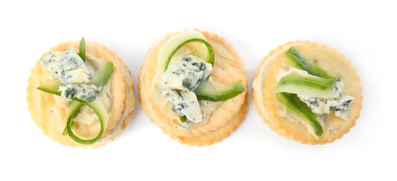 Photo of Delicious crackers with cheese and cucumber on white background, top view