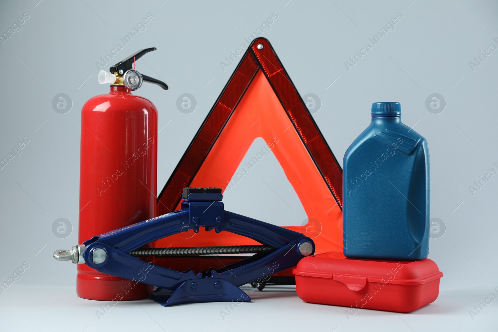 Photo of Set of car safety equipment on light grey background