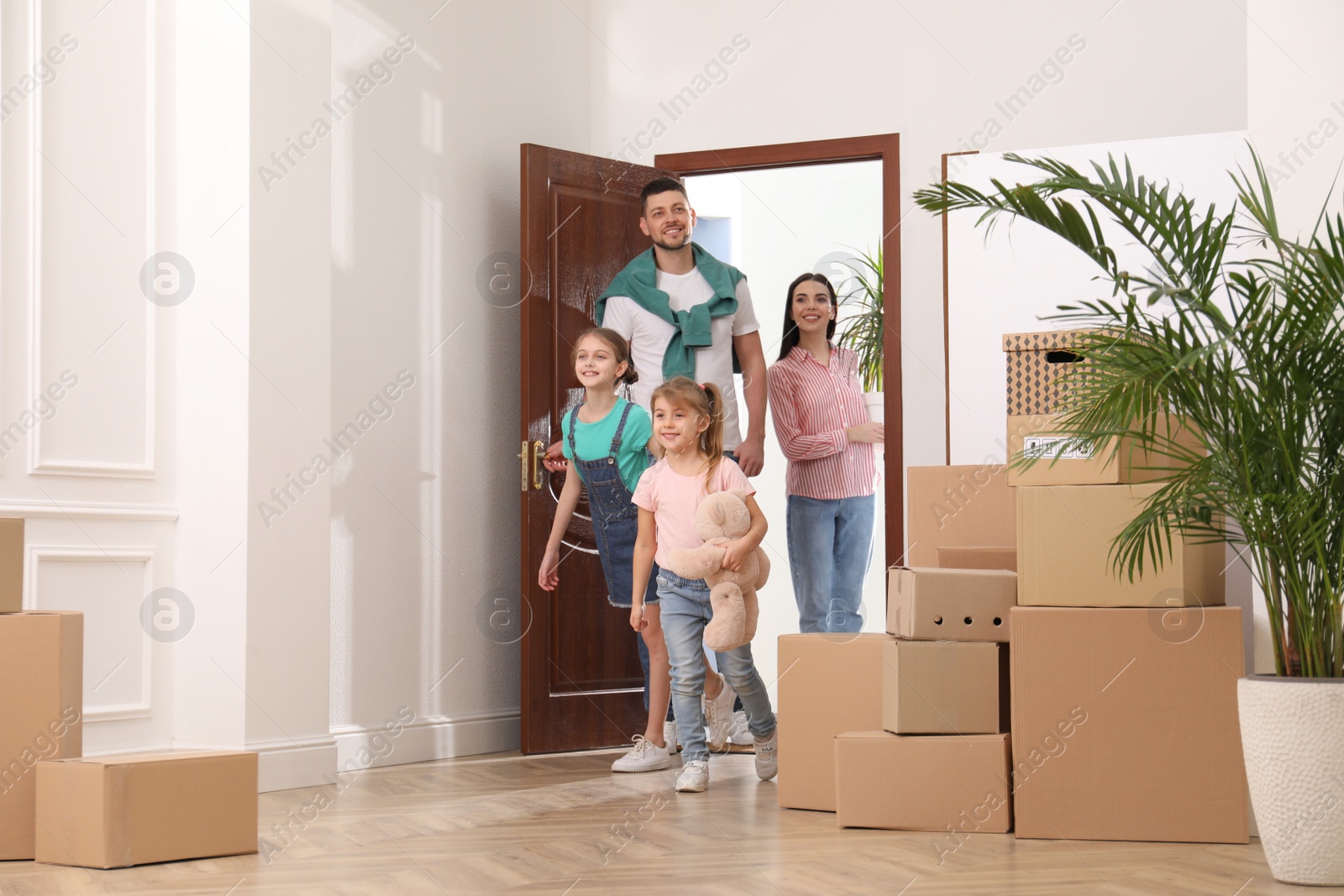 Photo of Happy family with children moving into new house