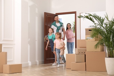 Happy family with children moving into new house