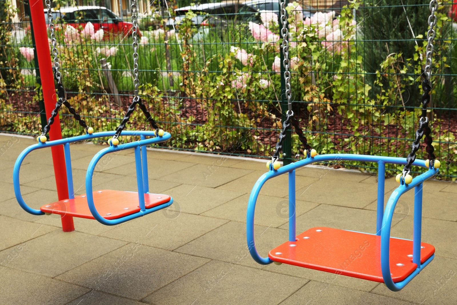 Photo of Swings on outdoor playground in residential area