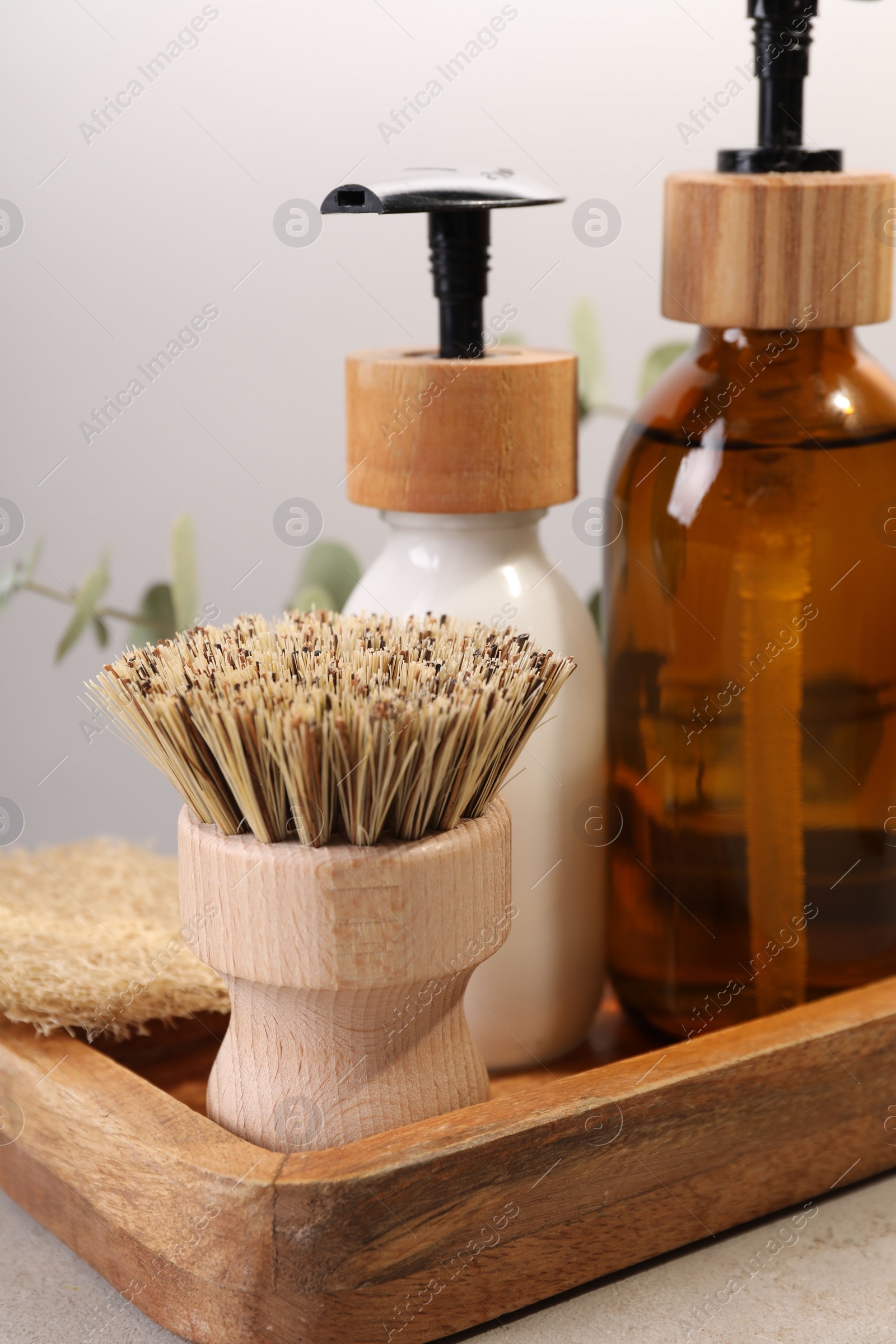 Photo of Cleaning brush, bottles and sponge on table