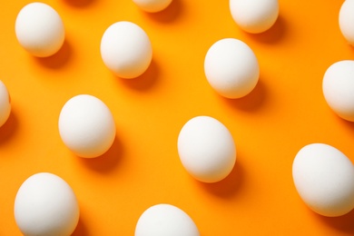 Photo of Raw white chicken eggs on color background