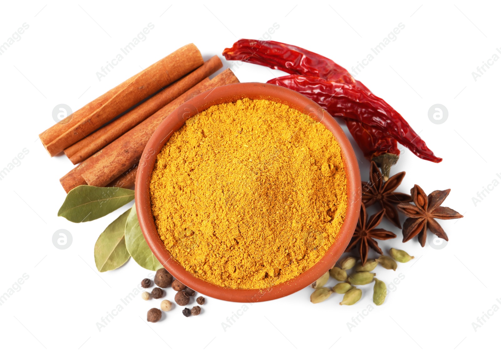 Photo of Curry powder in bowl and other spices isolated on white, top view