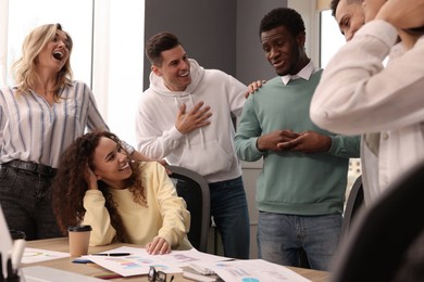 Photo of Team of employees working together in office. Startup project