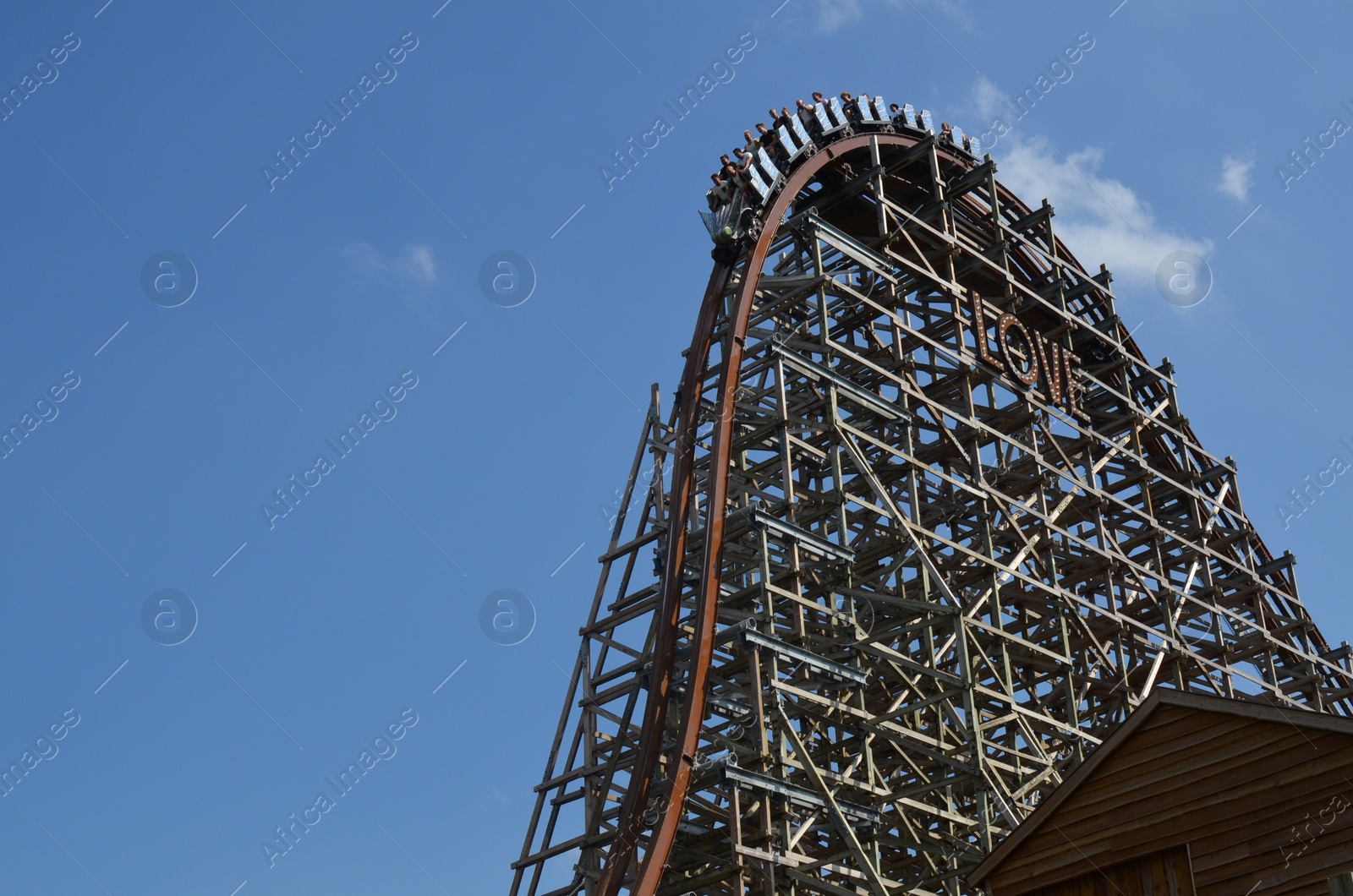Photo of Amsterdam, The Netherlands - August 8, 2022: People riding rollercoaster in Walibi Holland amusement park, low angle view