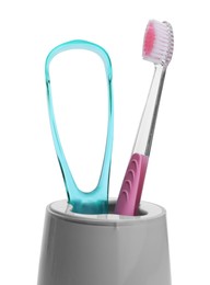 Photo of Holder with tongue cleaner and toothbrush on white background