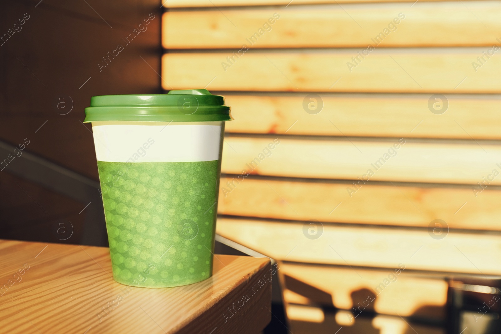 Photo of Cup of hot coffee on table in cafe