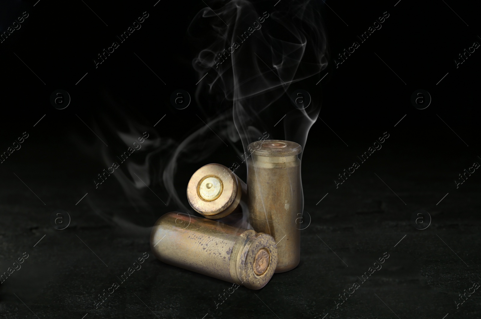 Image of Cartridge cases with smoke on black background