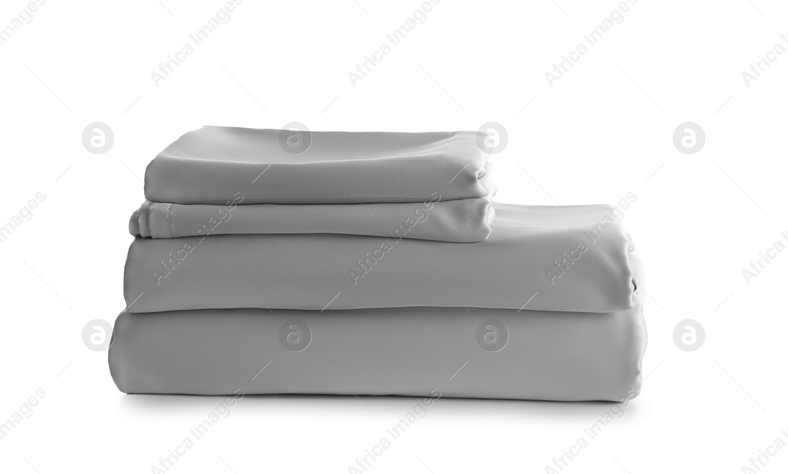 Photo of Stack of clean silky bed linen isolated on white