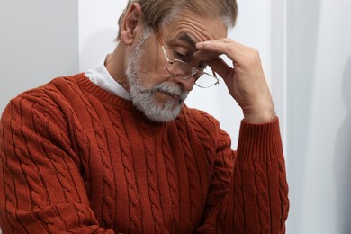 Photo of Upset senior man at home. Loneliness concept